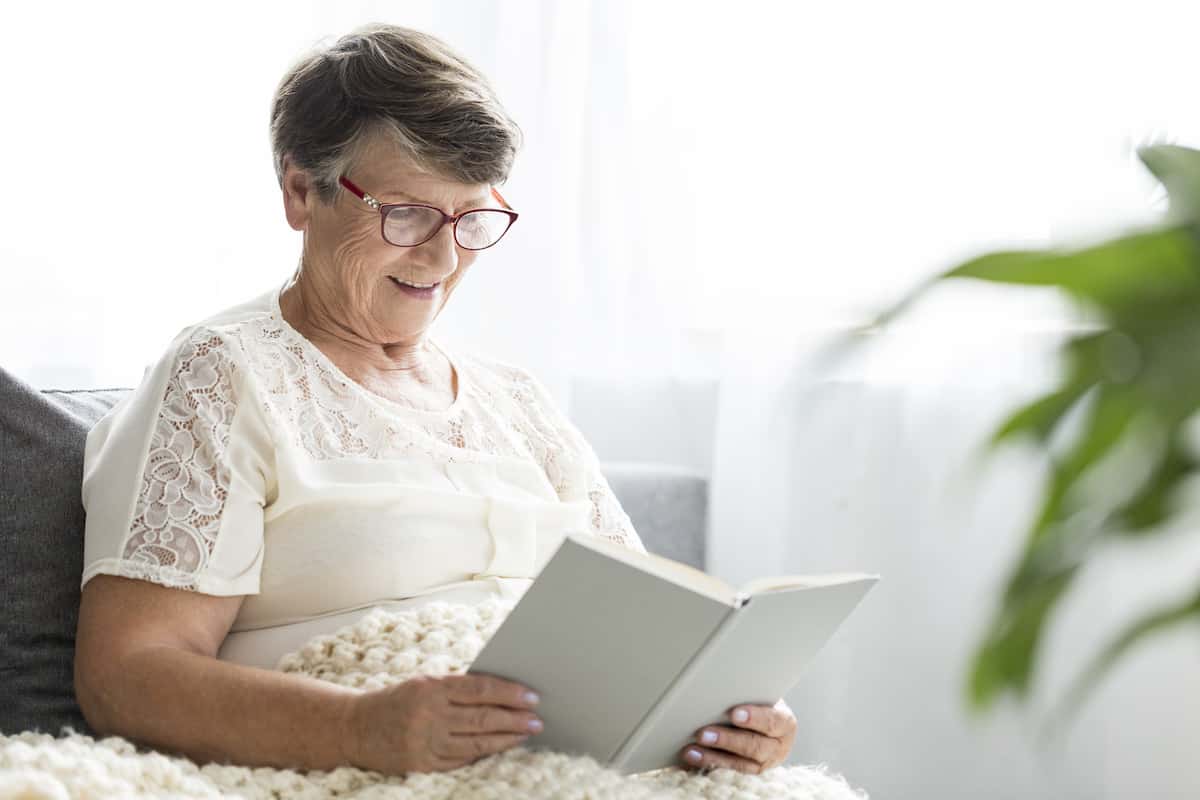 Older adult woman reading a book